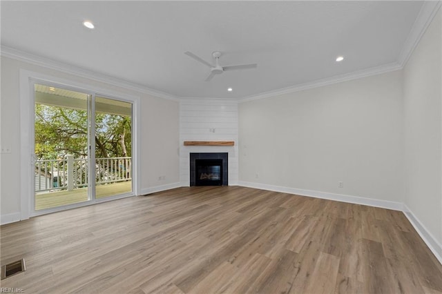 unfurnished living room with ceiling fan, a fireplace, crown molding, and light hardwood / wood-style floors