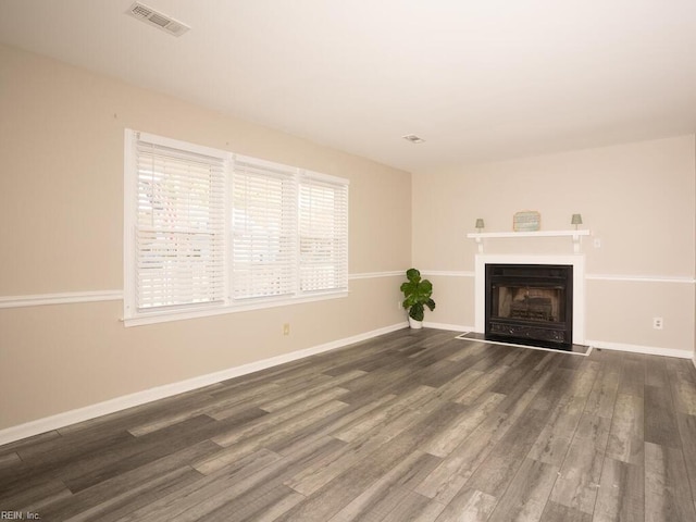 unfurnished living room featuring dark hardwood / wood-style floors