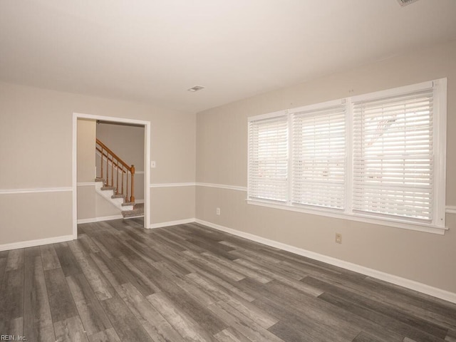 spare room featuring dark hardwood / wood-style floors