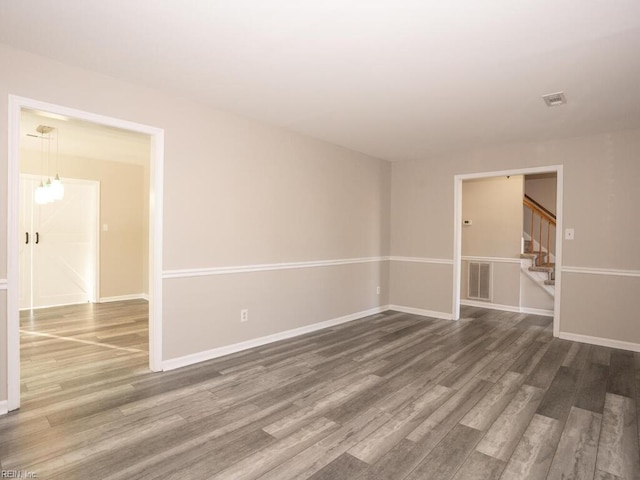 spare room featuring wood-type flooring