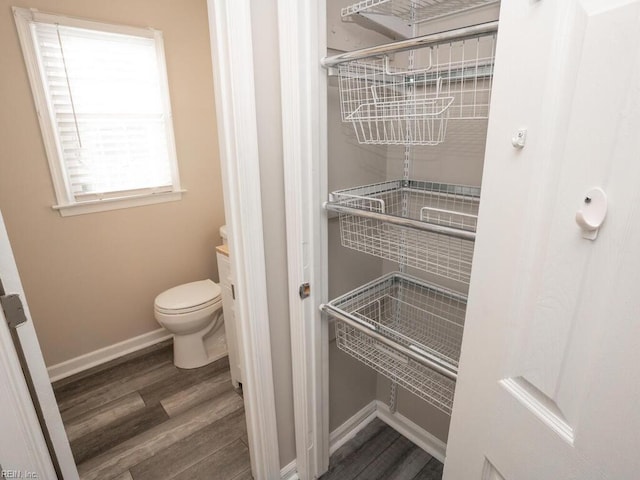 bathroom featuring hardwood / wood-style flooring and toilet