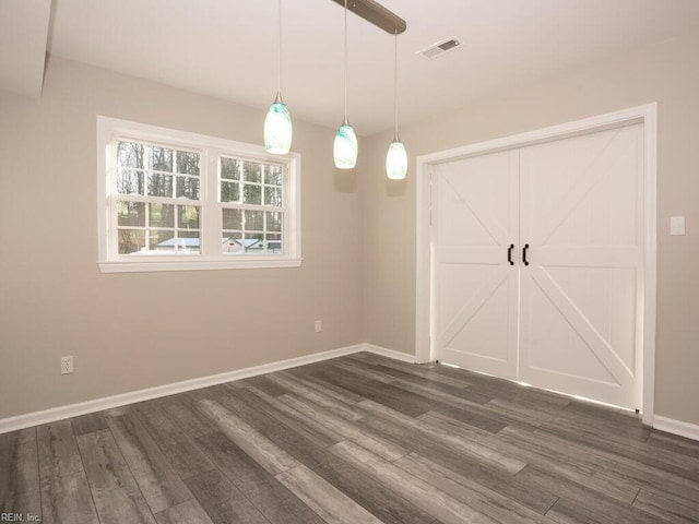 unfurnished dining area with dark hardwood / wood-style flooring