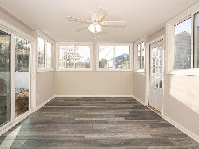 unfurnished sunroom with ceiling fan