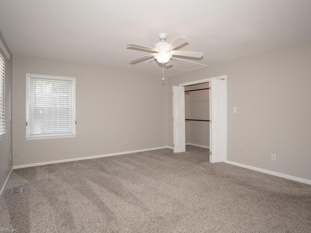 unfurnished bedroom featuring carpet, a closet, and ceiling fan