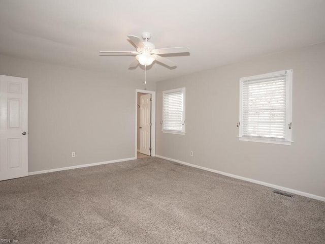 carpeted empty room featuring ceiling fan