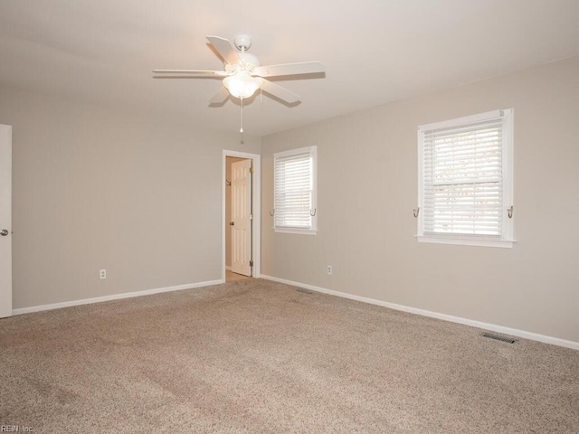 carpeted empty room featuring ceiling fan