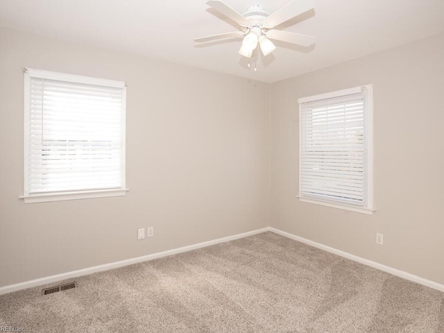 unfurnished room with ceiling fan and carpet floors