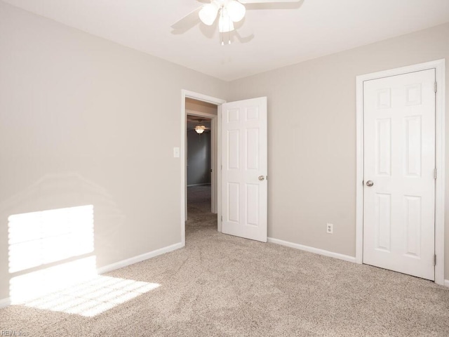 unfurnished bedroom with light colored carpet and ceiling fan