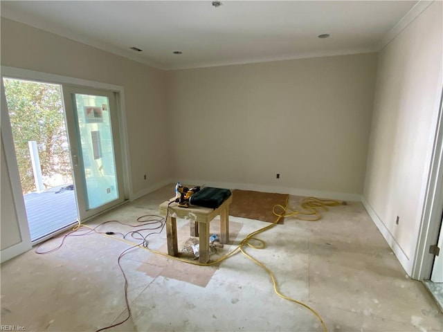 spare room with ornamental molding and baseboards