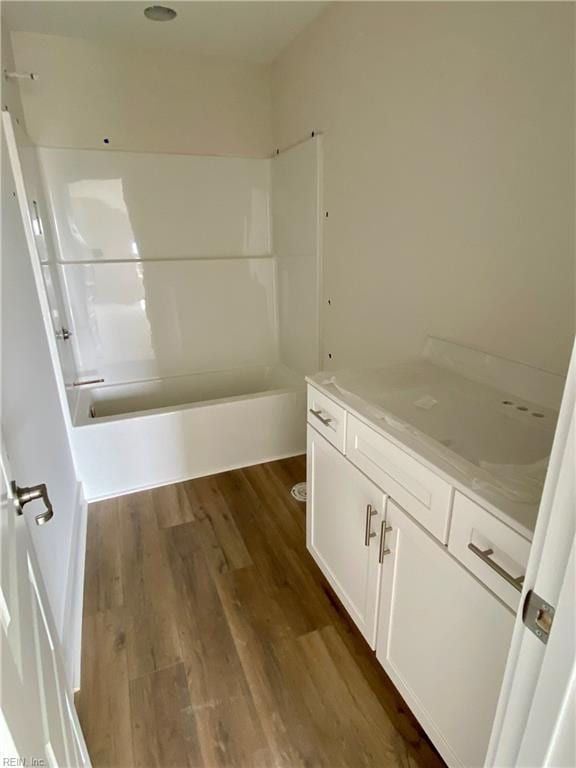 bathroom featuring shower / bath combination, wood finished floors, and vanity