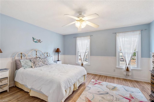 bedroom featuring ceiling fan and light hardwood / wood-style floors