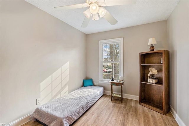 bedroom with light wood-type flooring and ceiling fan