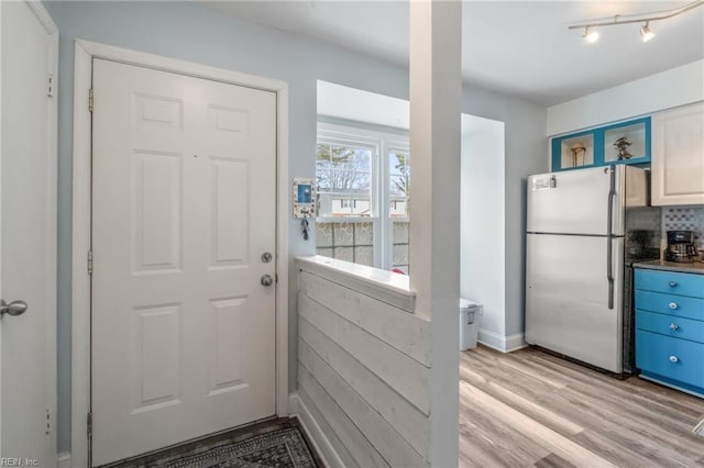 doorway to outside with light wood-type flooring