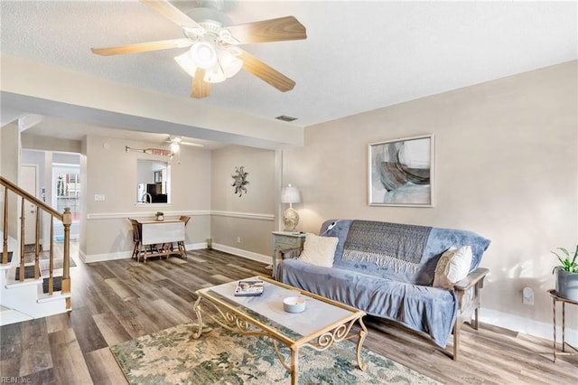 living room with ceiling fan and hardwood / wood-style flooring