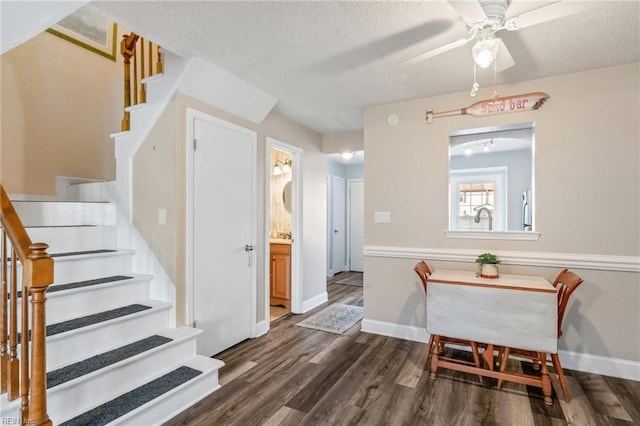 interior space with a textured ceiling, ceiling fan, and wood-type flooring