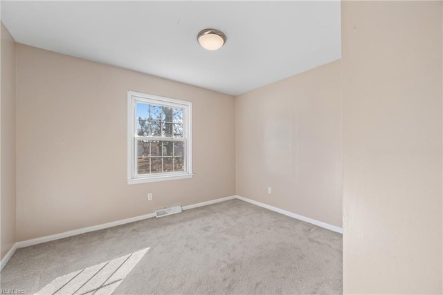 empty room featuring light carpet