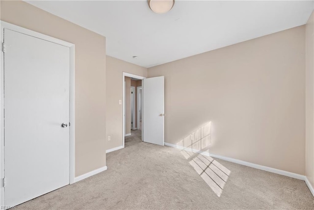 unfurnished bedroom featuring light carpet