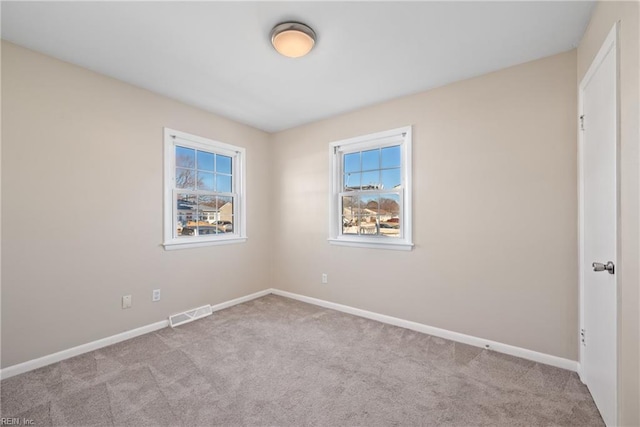 unfurnished room with light carpet