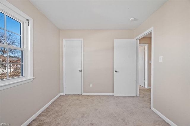 unfurnished bedroom with light colored carpet