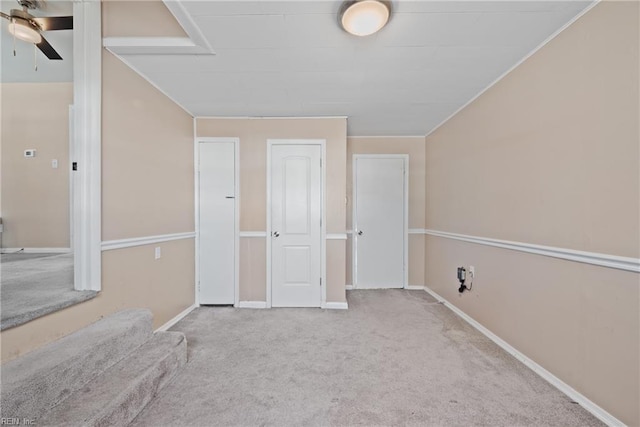 interior space featuring light colored carpet and ceiling fan