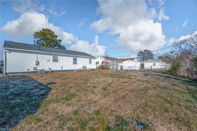 rear view of property featuring a lawn