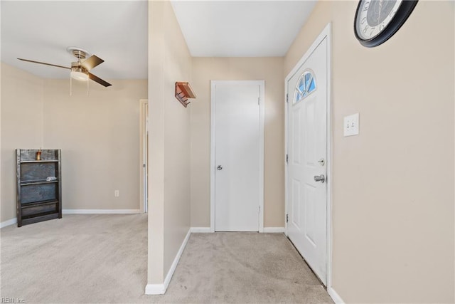 carpeted entryway with ceiling fan