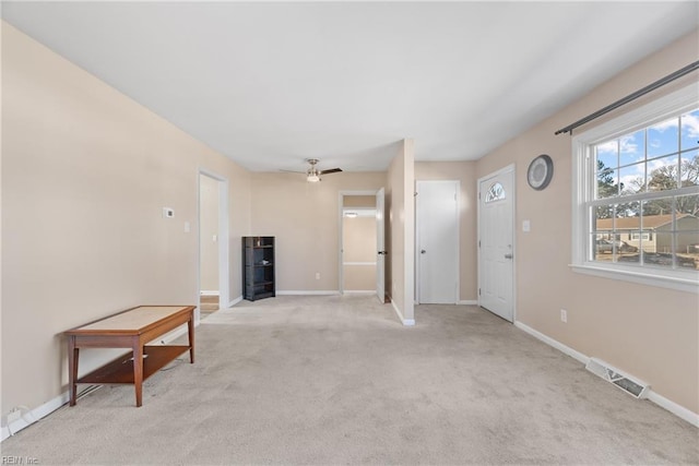 carpeted spare room featuring ceiling fan