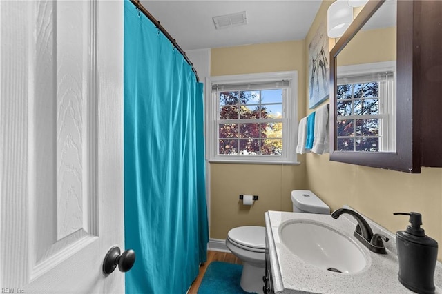 bathroom featuring vanity and toilet