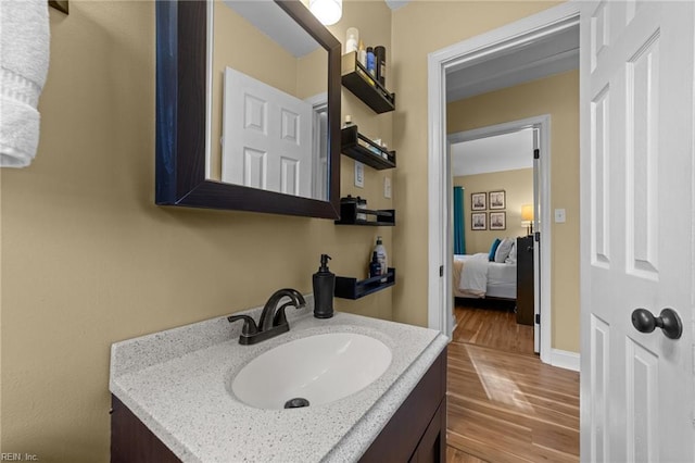 bathroom with hardwood / wood-style floors and vanity