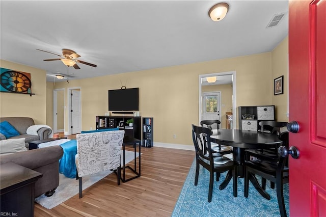 living room with ceiling fan and light wood-type flooring