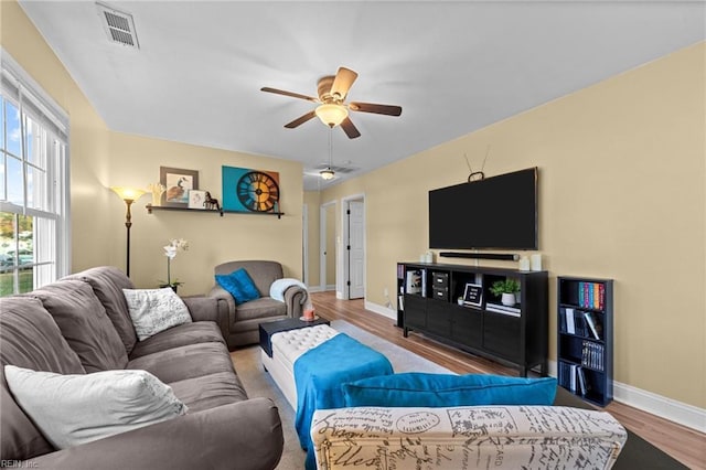 living room with hardwood / wood-style flooring and ceiling fan