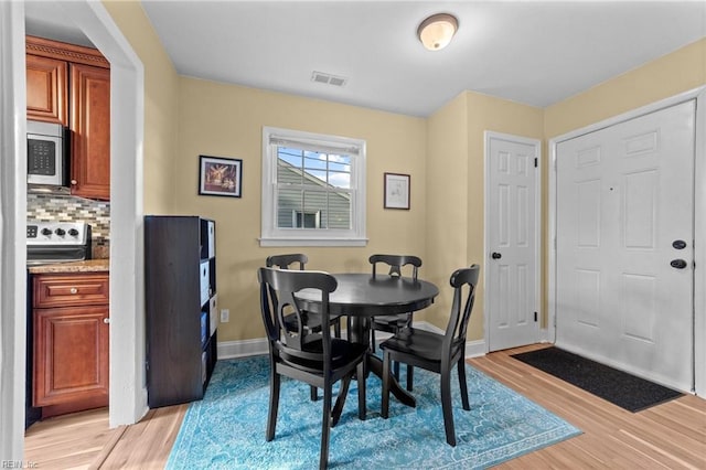 dining area with light hardwood / wood-style floors