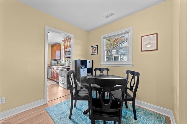 dining space with light wood-type flooring