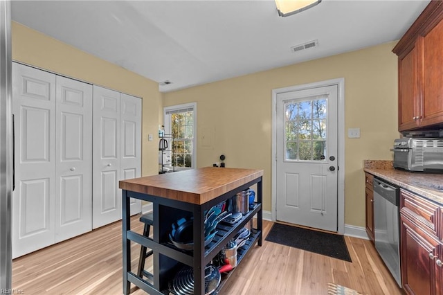 kitchen featuring stainless steel dishwasher and light wood-type flooring