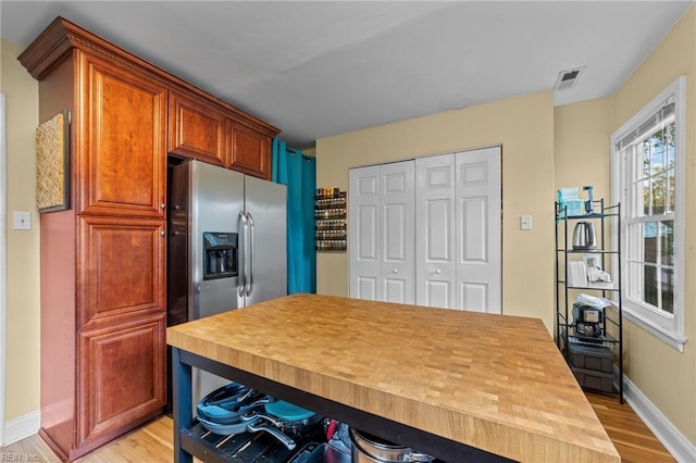 kitchen featuring light wood-type flooring and stainless steel fridge with ice dispenser