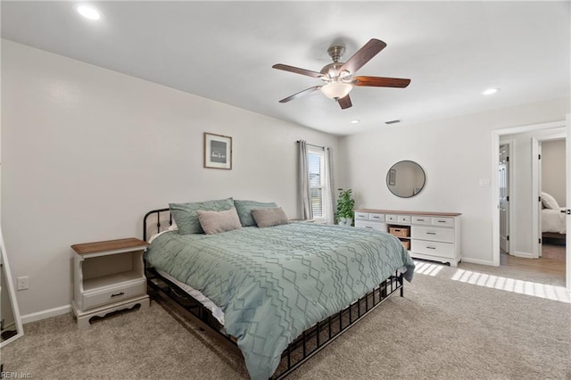 bedroom with ceiling fan and light colored carpet