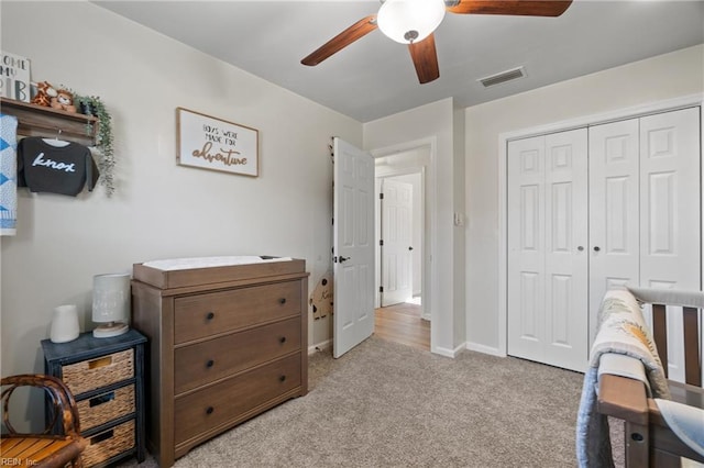 carpeted bedroom featuring ceiling fan and a closet