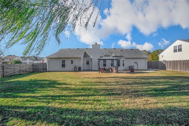 back of house featuring a gazebo, a patio area, and a lawn