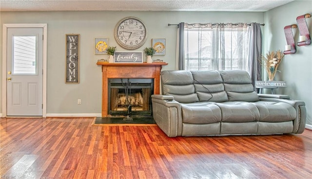 living room with hardwood / wood-style flooring, plenty of natural light, and a textured ceiling