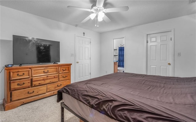 carpeted bedroom with ceiling fan and connected bathroom