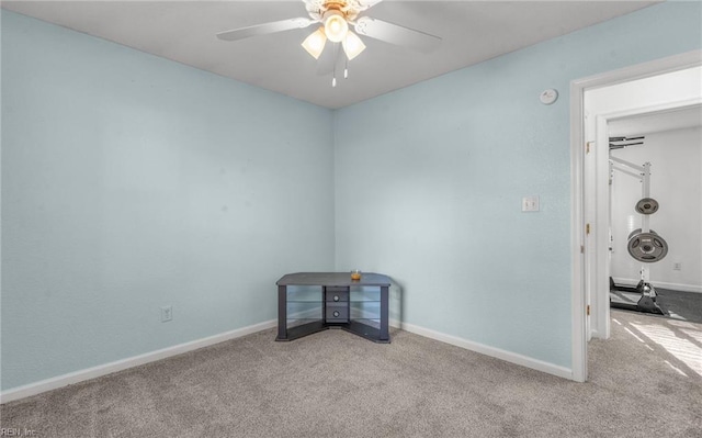 carpeted empty room featuring ceiling fan