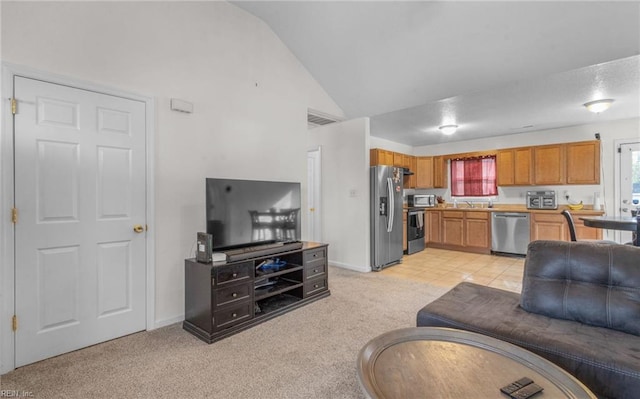 carpeted living room featuring sink and vaulted ceiling