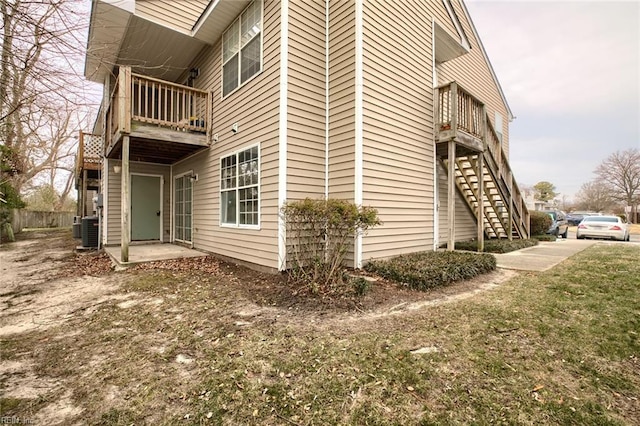 view of property exterior featuring a balcony, a patio area, and cooling unit