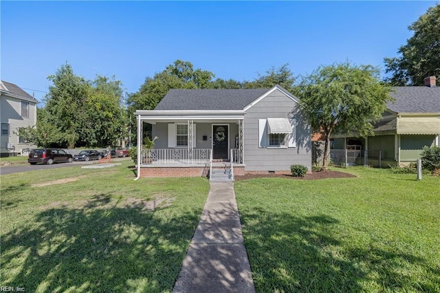 bungalow-style house with a front lawn and covered porch