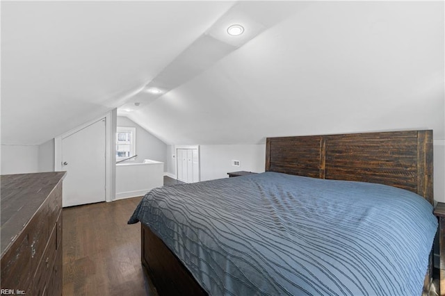 bedroom featuring dark hardwood / wood-style flooring and lofted ceiling