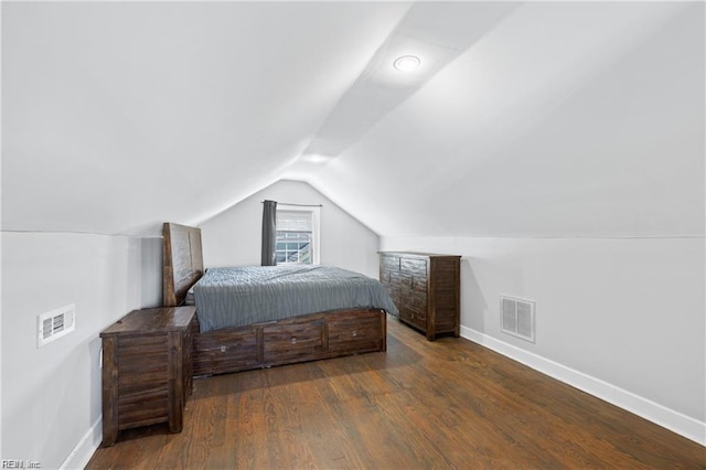 bedroom with dark wood-type flooring and vaulted ceiling