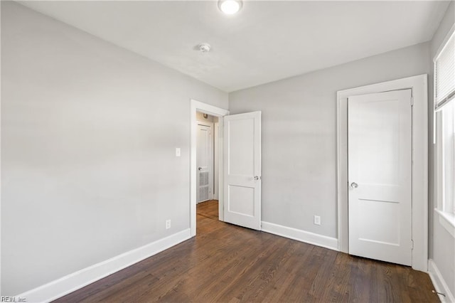 unfurnished bedroom featuring dark wood-type flooring