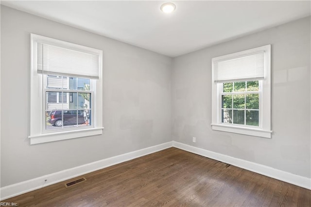 empty room with dark wood-type flooring