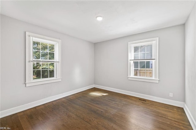 empty room featuring dark wood-type flooring