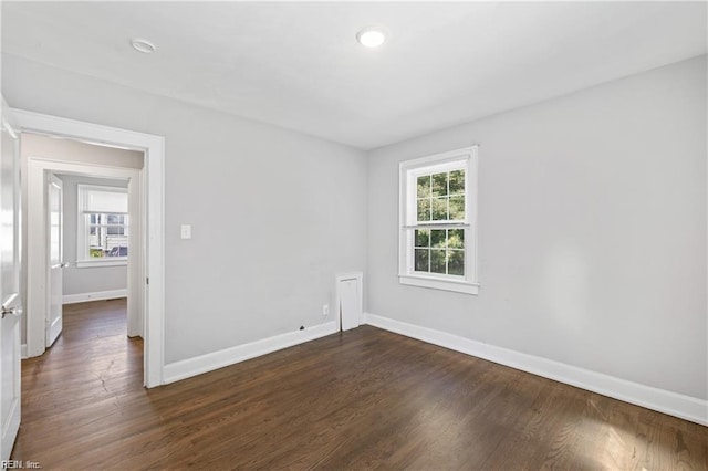 unfurnished room with dark hardwood / wood-style floors